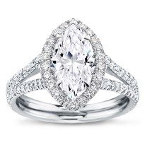 a white gold ring with an oval cut diamond in the center and double rows of pave set diamonds on each band