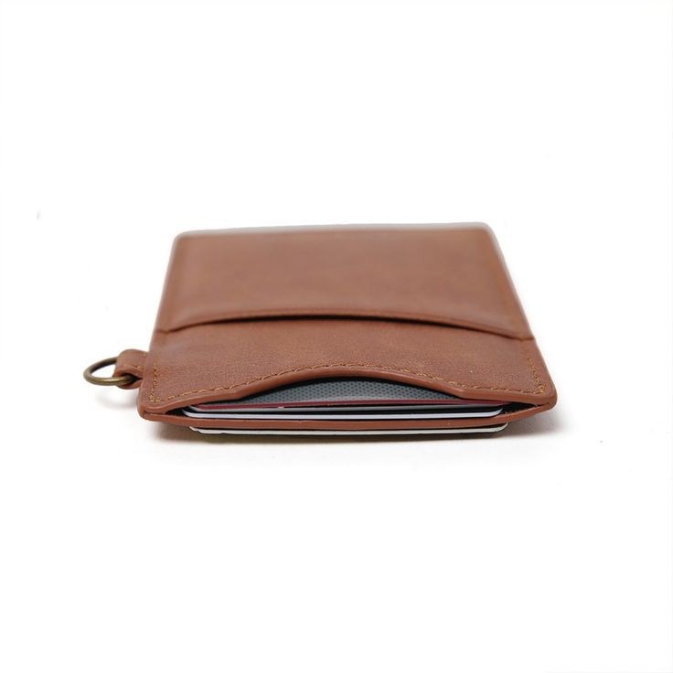 Our Vertical Wallet is a stylish and slim leather wallet, featuring a signature elastic pocket that securely holds cards while adding a unique touch of style. It's patented design allows you to carry your cards with ease and comfort. Get the sleek and slim Vertical Wallet to stay organized and stylish. Thread Wallets, Slim Leather Wallet, Wrist Lanyard, Lip Balm Holder, Key Lanyard, Your Cards, Key Hook, Minimalist Wallet, Slim Wallet