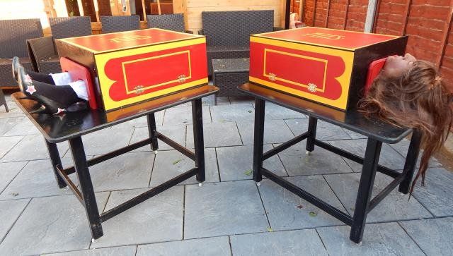 two tables made to look like they have pizza boxes on top of them, and one is upside down