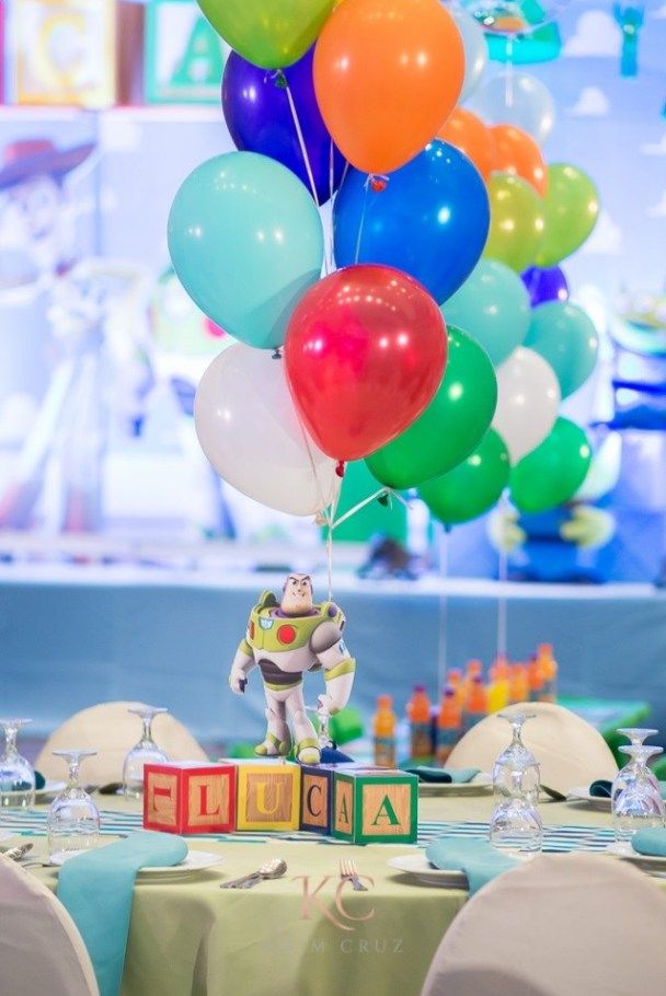 a table topped with lots of colorful balloons