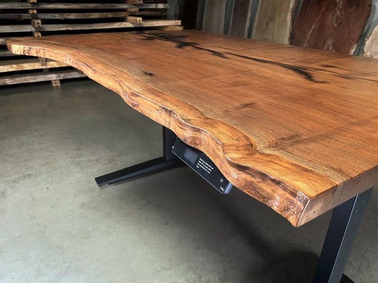 a wooden table with metal legs in a warehouse