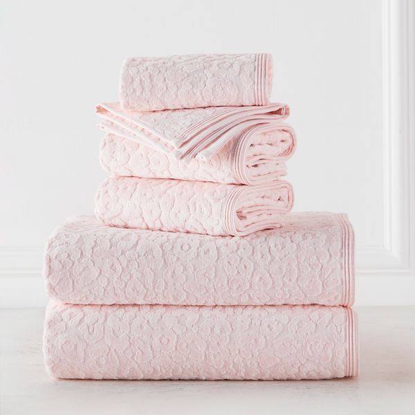 pink towels stacked on top of each other