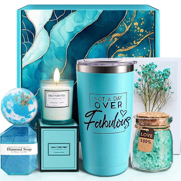 a blue gift box containing a candle, teal vase and other items for the holiday season