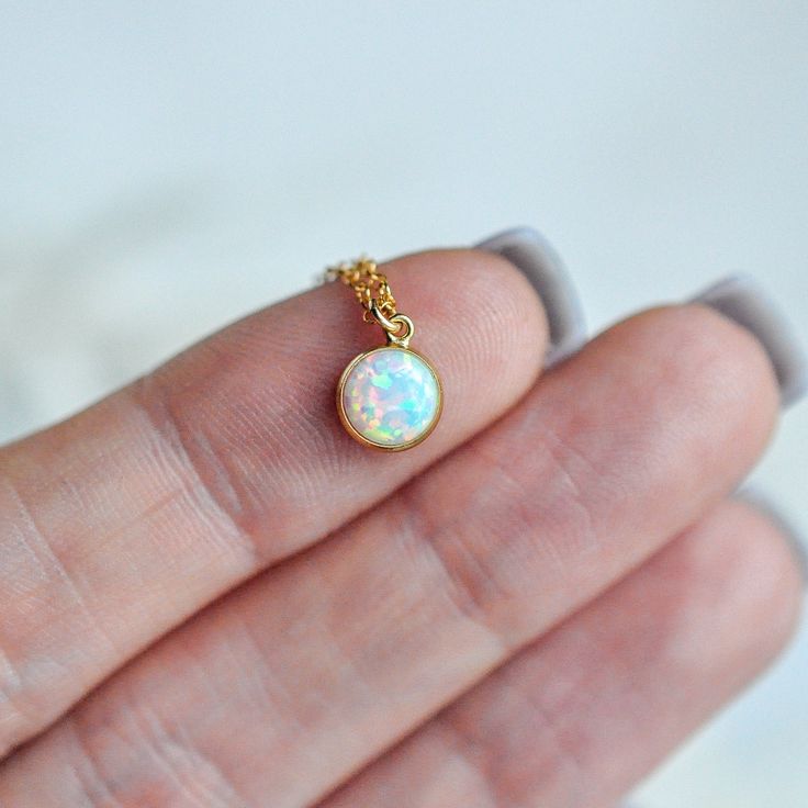 NEW OPAL! An absolutely stunning stone with vibrant colors like blue, pink, light purples.. it shines bright when it hits the light and is a statement piece while also being delicate and dainty. The opal is actually the October birthstone so this would make a great gift, or a great every day piece for yourself. The stone itself is 6mm which is about .25"I recommend wearing this on a shorter chain like a 15-16"We also sell this as a set to match the opal earrings, which you can view here:https:// Adjustable Opal Birthstone Jewelry, Minimalist Iridescent Round Jewelry, Delicate Opal Gemstone Jewelry, Delicate Opal Jewelry With Birthstone, Delicate Opal Birthstone Jewelry, Minimalist Ethiopian Opal Round Jewelry, Hypoallergenic Round Opal Jewelry, Dainty Round Ethiopian Opal Jewelry, Dainty Ethiopian Opal Round Jewelry