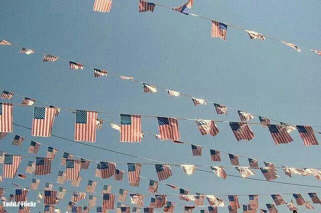 many american flags are hanging from a line