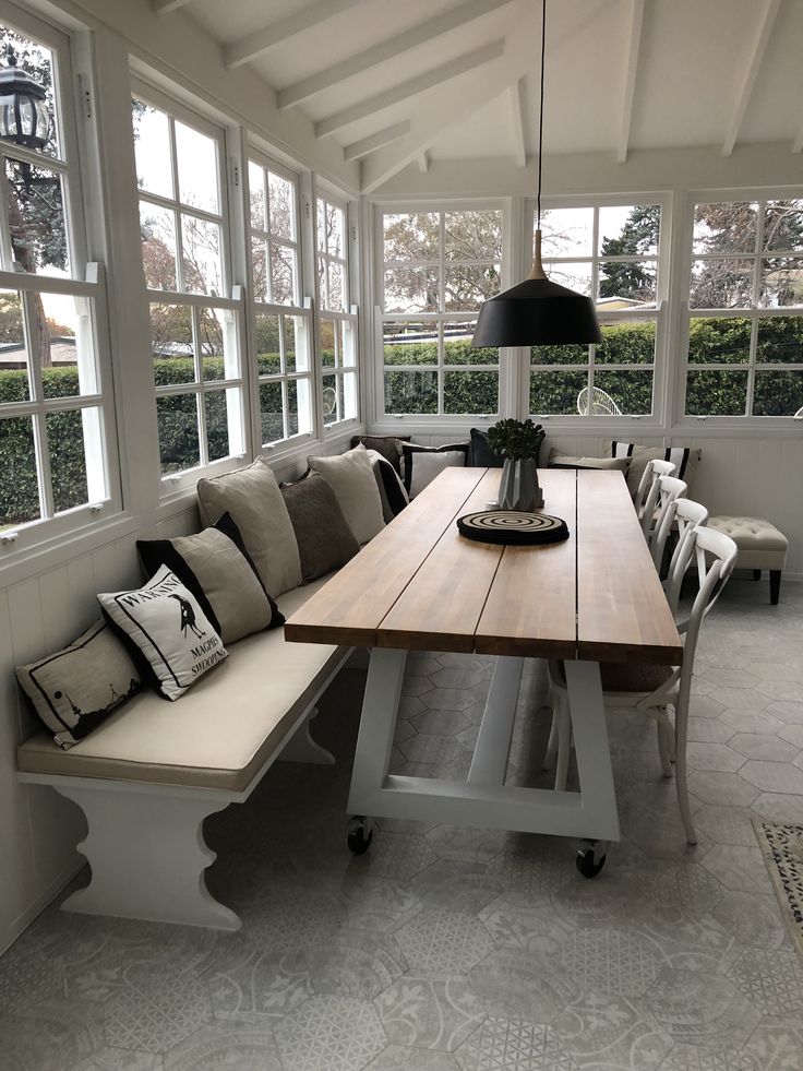 a long table sitting in the middle of a room with two benches on each side