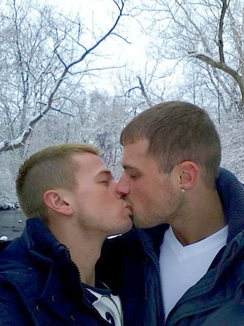 two men kissing each other in front of snow covered trees with a quote from the same person