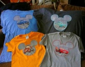 four tshirts with mickey mouse and cars on them sitting on a couch in front of a window