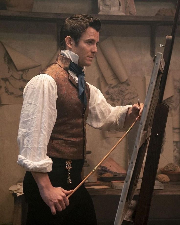 a young man is painting on an easel