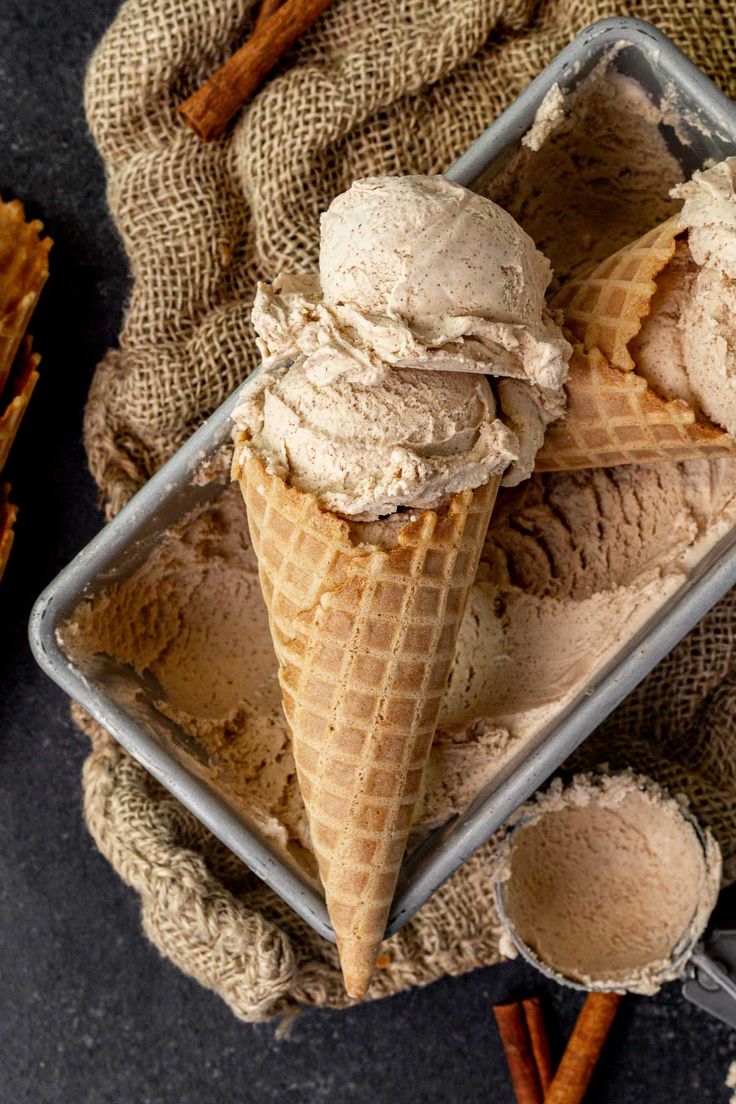 two scoops of ice cream in a glass dish