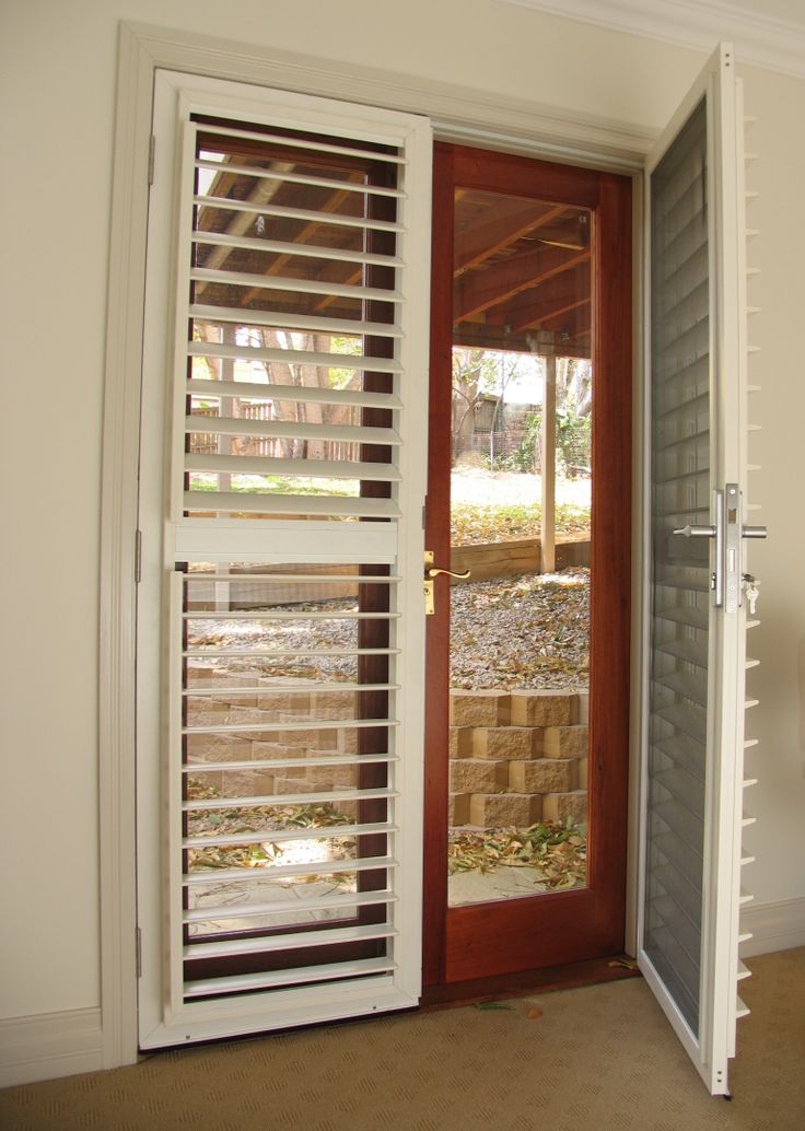 an open door with blinds on the outside