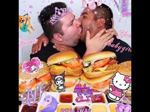 two men kissing each other while surrounded by food