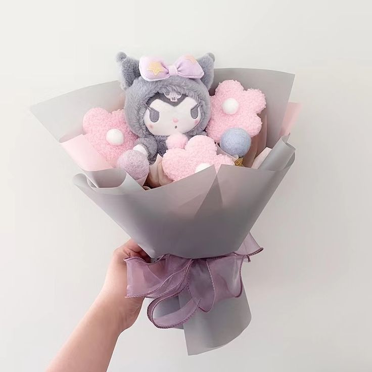 a person holding a bouquet of stuffed animals