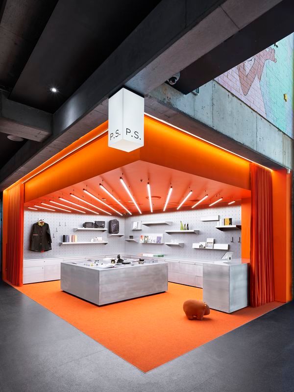 an orange and white store with lots of shelves on the wall next to each other