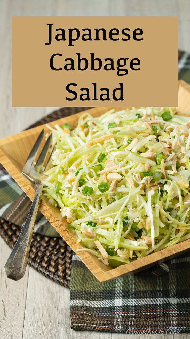 japanese cabbage salad on a wooden plate with a fork and napkin in front of it