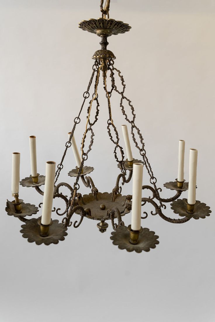 a chandelier with six candles hanging from it