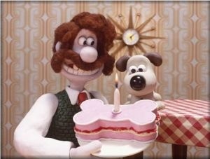 a cartoon character holding a birthday cake with a dog on the table next to it