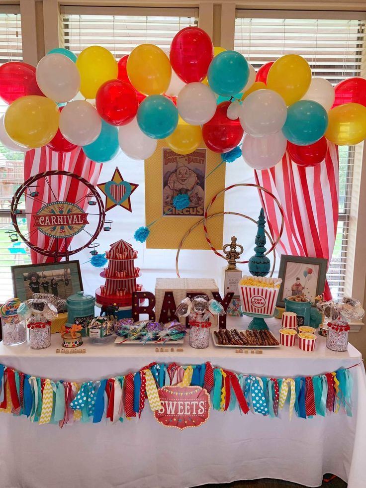 a table topped with balloons and decorations