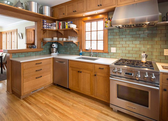 a kitchen with wooden cabinets and stainless steel stove top oven in the center of the room