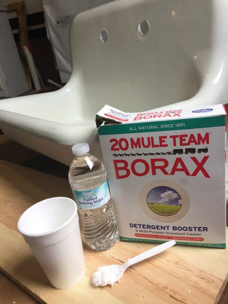 a box of borax next to a bottle of water and a toothbrush