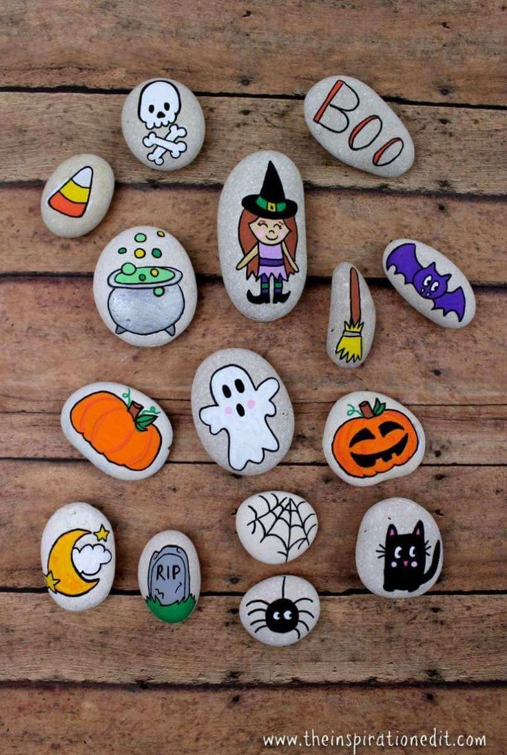 painted rocks with halloween characters and pumpkins are arranged in the shape of a circle