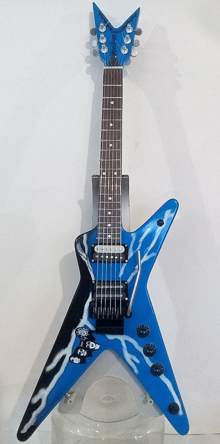 a blue and black guitar sitting on top of a table