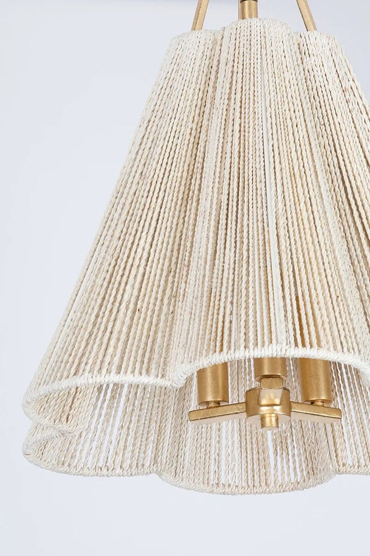 a white chandelier hanging from a ceiling fixture with two brass fittings on each end