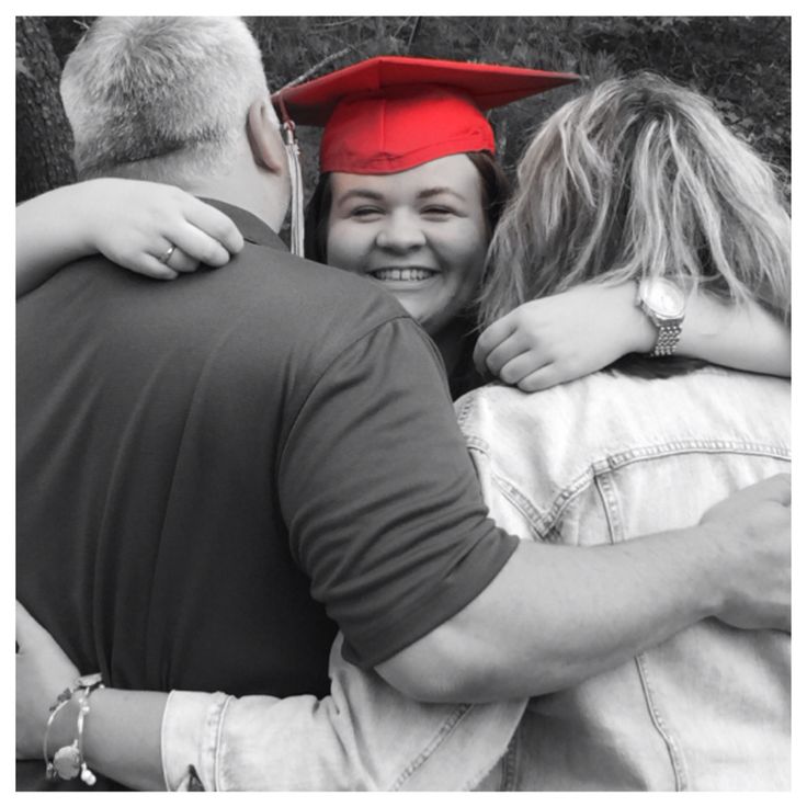 two people hugging each other while wearing graduation caps