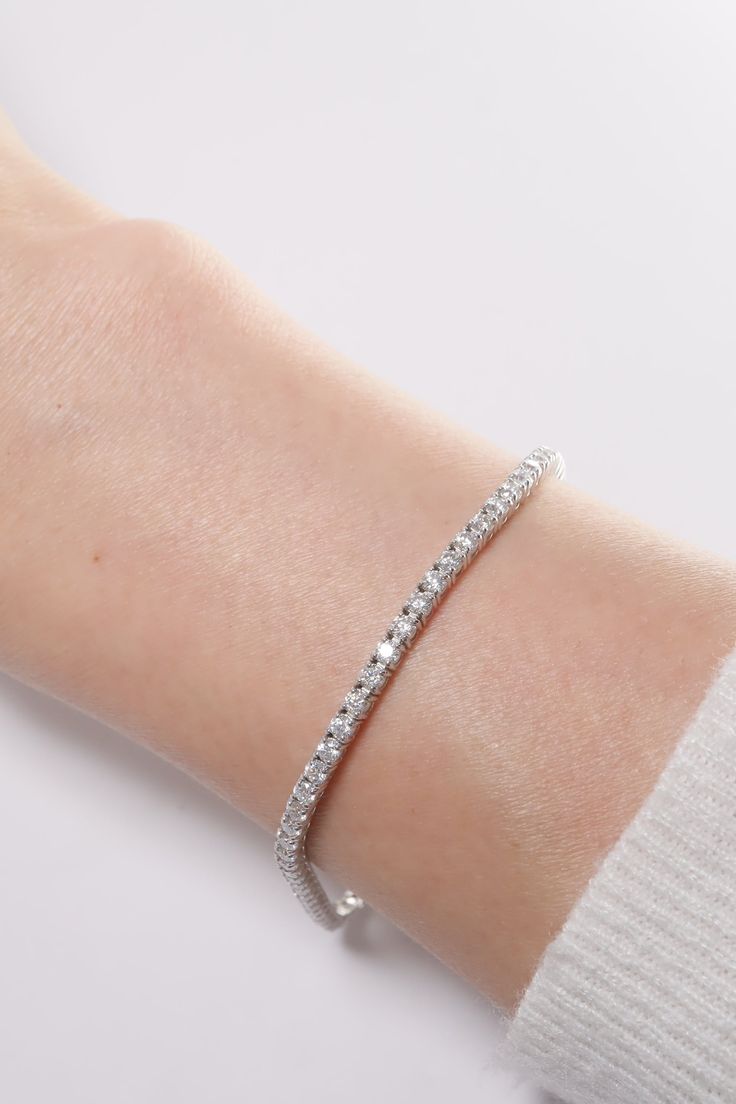 PLX487 Our 2.1mm Lab Rectangle Cut Tennis Bracelet is meticulously handcrafted in Korea, delivering a unique blend of classic and contemporary aesthetics. Made from 14K solid white gold, this bracelet features a tennis design adorned with lab-created rectangle cut stones, providing a timeless and elegant look. This bracelet is perfect for adding a touch of elegance and sparkle to your everyday look or for special occasions. This tennis bracelet also makes a great gift for occasions like birthday Modern White Tennis Bracelet For Formal Occasions, Modern White Diamond Cut Bracelet, Modern White Gold Sterling Silver Tennis Bracelet, Elegant White Sterling Silver Tennis Bracelet, Modern Flexible White Gold Diamond Bracelet, Timeless White Diamond Sterling Silver Bracelet, Timeless White Sterling Silver Diamond Bracelet, Elegant Flexible White Gold Bangle, White Sterling Silver Bracelet With Diamond Cut