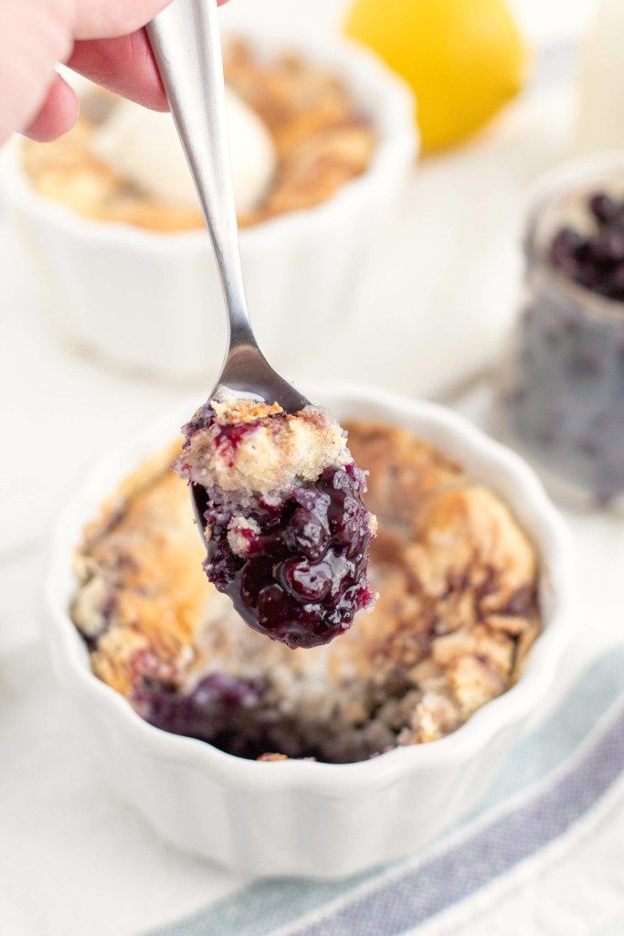 a spoonful of blueberry baked oatmeal in a white bowl