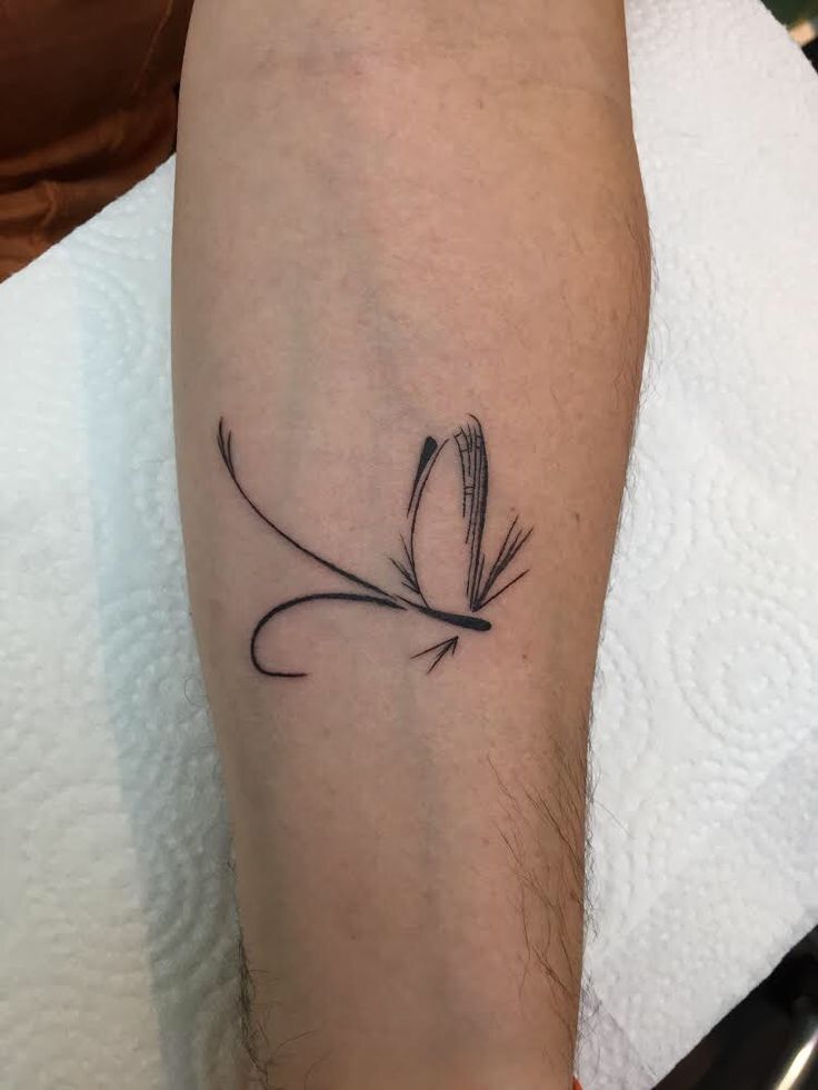 a small black and white flower tattoo on the leg