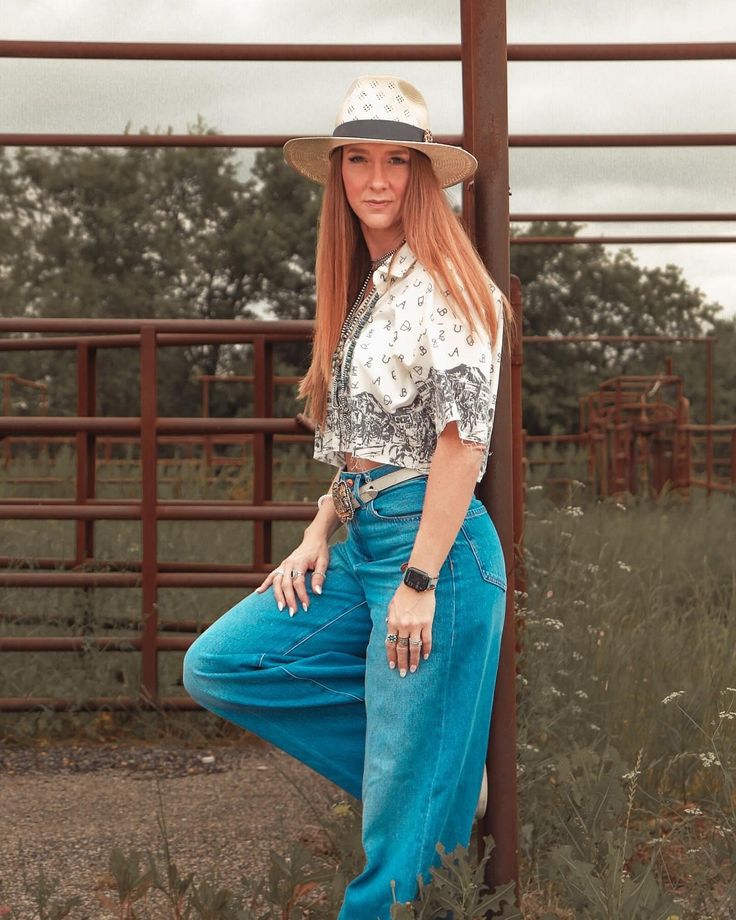 Get your country vibe on with the Tombstone Ghostown Cropped Pearl Snap. A nod to the Wild West with its cropped length and pearl snap buttons. Designed with a loose fit for comfort and unique cattle brand details for a touch of individuality. Giddy up!(Yeehaw!) Medium Wash Bottoms For Spring Rodeo, Casual Bottoms For Ranch In Fall, Women Pearl Snap Outfit, Western Style Spring Tops With Buttons, Spring Tops With Pockets For Rodeo, Casual Bottoms For Rodeo In Spring, Casual Spring Bottoms For Rodeo, Western Style Denim Bottoms For Spring, Rodeo Tops With Snap Buttons In Relaxed Fit