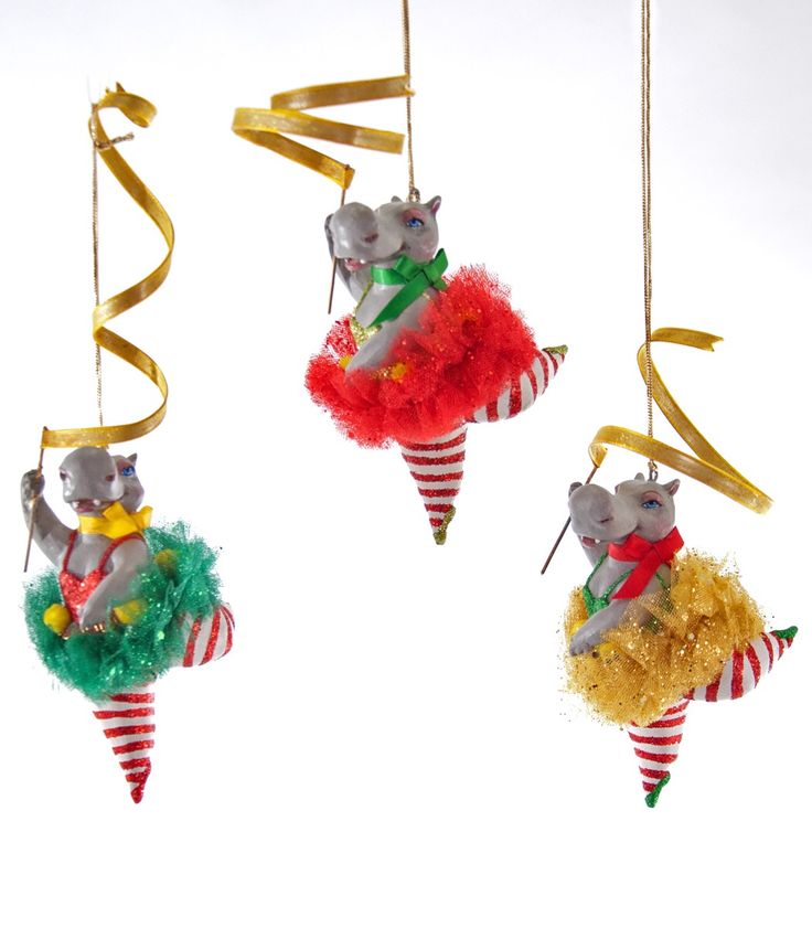 three christmas ornaments hanging from strings in the shape of mice