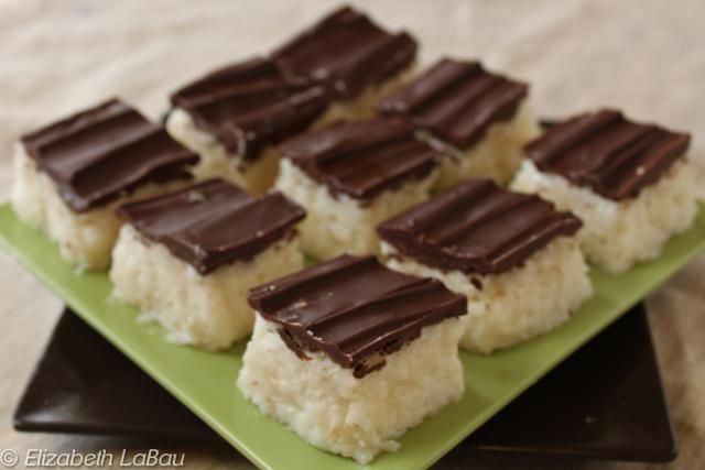 several pieces of chocolate and coconut on a green plate