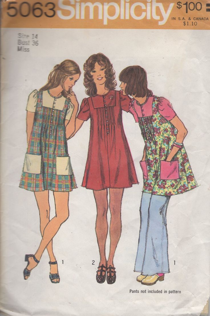 three women in dresses are standing next to each other and one has her hand on the back of another woman's shoulder