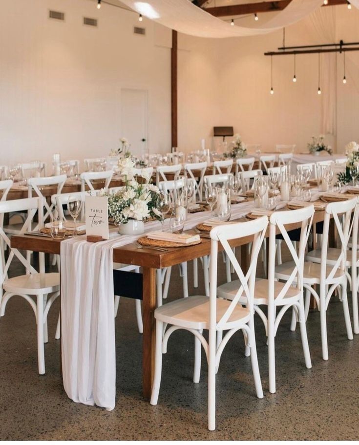 the tables and chairs are set up with white linens on them for a wedding reception