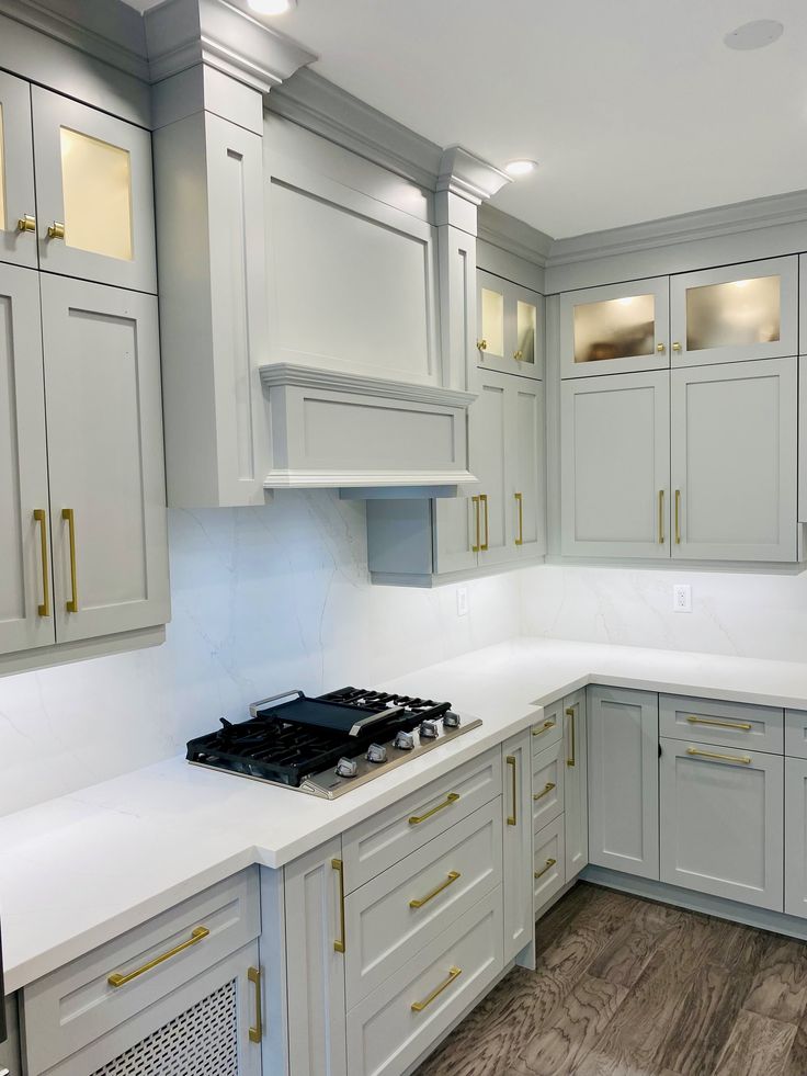 Cook in style! This stunning kitchen brings together soft gray tones and luxurious gold hardware for a contemporary and elegant space. Pin now for your home inspiration! 🏡✨ #KitchenGoals #ModernDesign #HomeInspo Gold Fixtures Kitchen, Gray And Gold Kitchen, Kitchen With Gold Accents, Kitchen Gray, Fixtures Kitchen, Gold Fixtures, Gray Kitchen, New House - Kitchen, Gold Kitchen