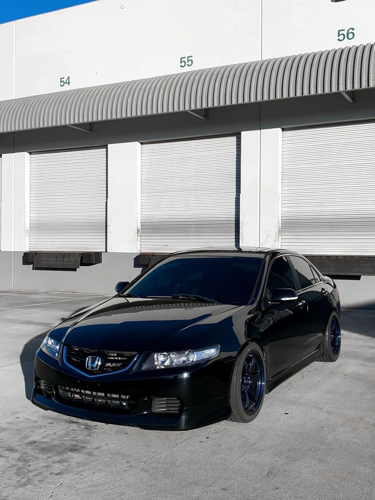 a black car parked in front of a building