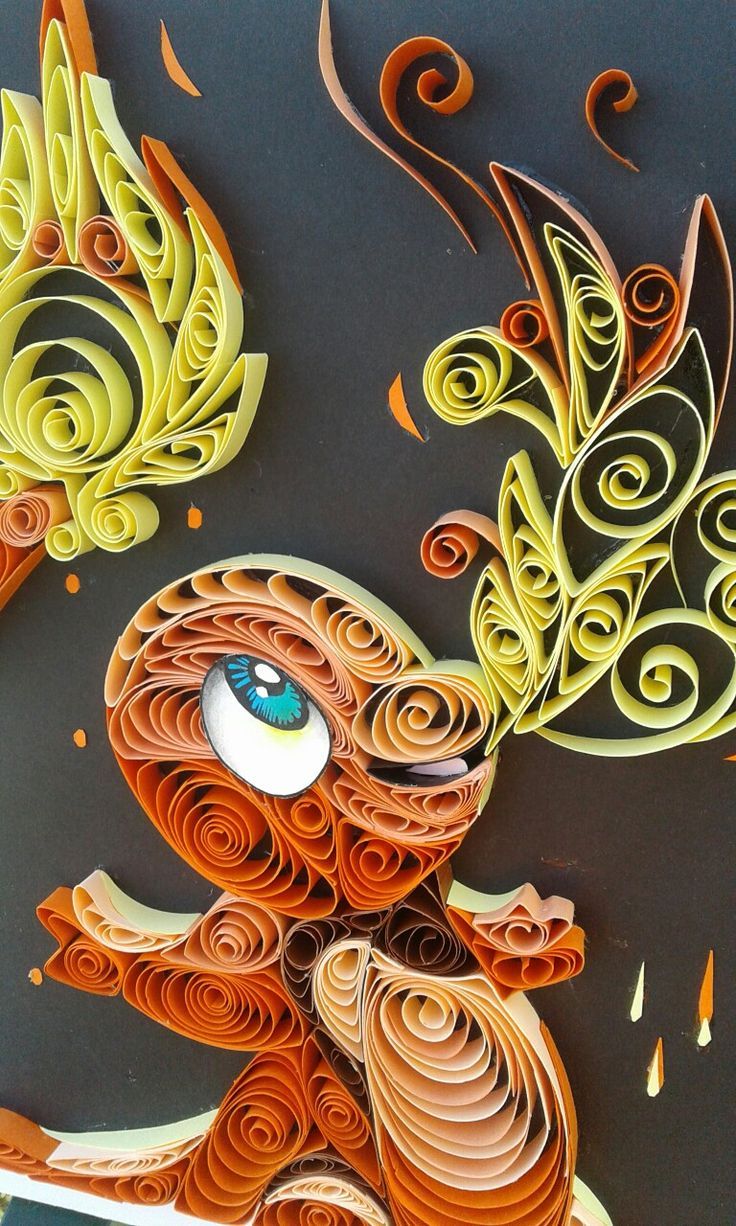 an intricately designed piece of art made out of paper and colored with blue eyes