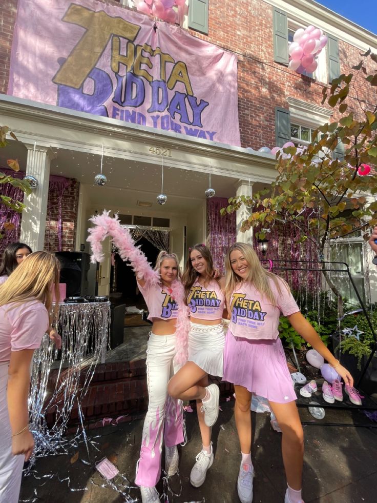 three girls in pink cheerleader outfits are posing for the camera while confetti is thrown around them