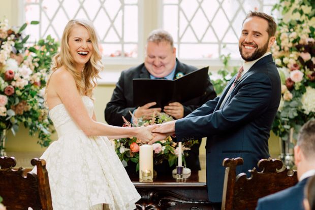 a bride and groom holding hands at their wedding ceremony