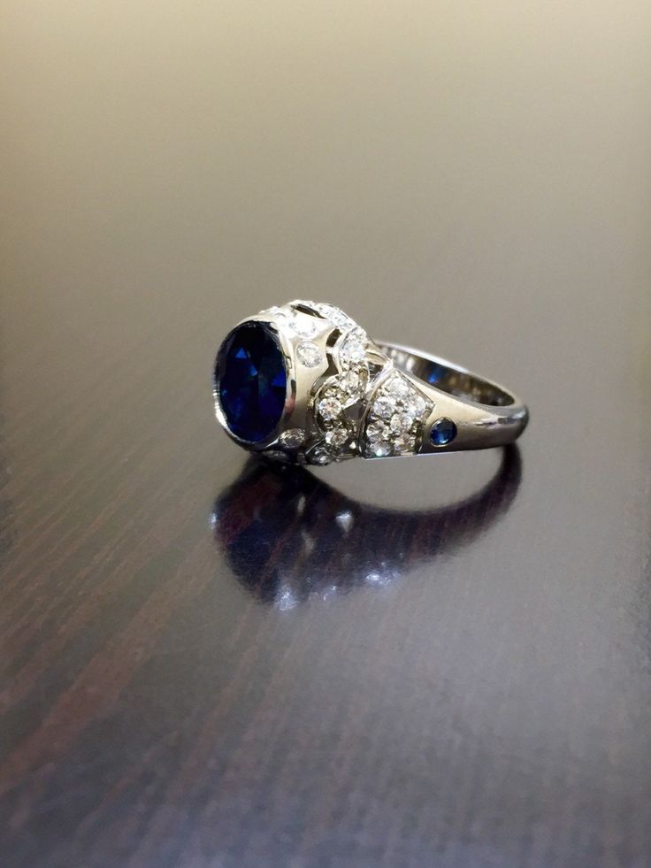 DeKara Designs Clearance Metal- 14K Yellow Gold, .583. Stones- Center 1 Round Ceylon Blue Sapphire 2.25 Carats, 2 Round Sapphire 0.05 Carats, 40 Diamonds G Color VS2 Clarity, 0.72 Carats. Size- Ring is a 6, and could be sized up or down at no additional cost! FREE SIZING Want the ring entirely hand engraved? No problem! Just go to the following link... https://www.etsy.com/listing/280526214/art-deco-14k-white-gold-sapphire-diamond?ga_search_query=sapphire+ring&ref=shop_items_search_8 Art Dec Luxury Sapphire Ring With Round Stone, Luxury Sapphire Diamond Ring With Polished Finish, Luxury Sapphire Ring With Round Stone For Formal Occasions, Luxury Cluster Ring With Sapphire In Round Cut, Luxury Formal Rings With Lab-created Sapphire, Luxury Sapphire Cluster Ring With Round Cut, Elegant Lab-created Sapphire Ring For Wedding, Exquisite Round Cut Sapphire Wedding Ring, Formal Sapphire Diamond Cut Ring