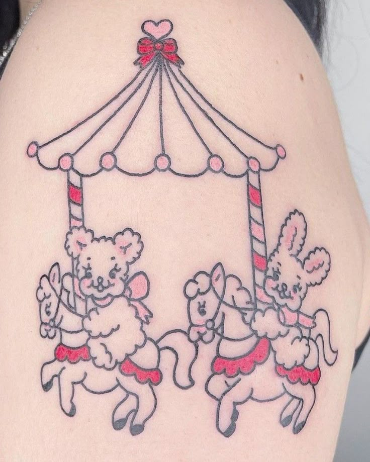 a woman with a tattoo on her back has an image of two teddy bears riding a carousel