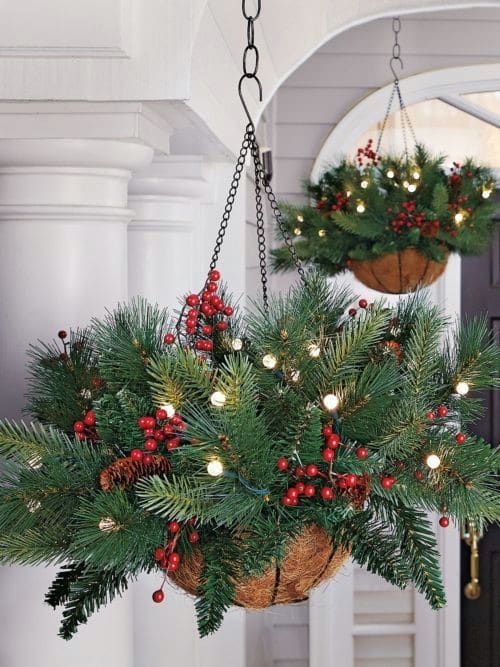 two hanging baskets filled with christmas decorations