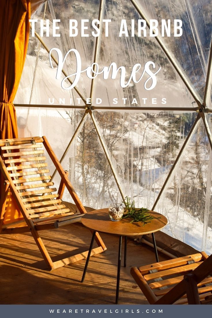 two wooden chairs sitting in front of a glass dome