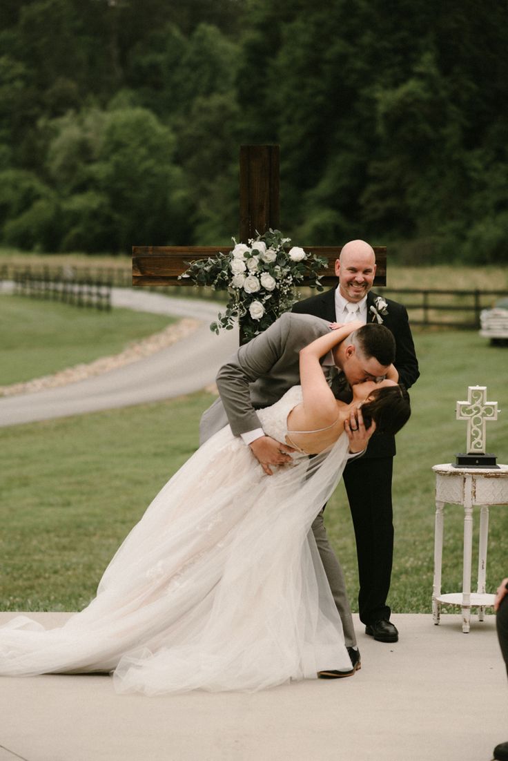 a bride and groom kissing at their wedding ceremony