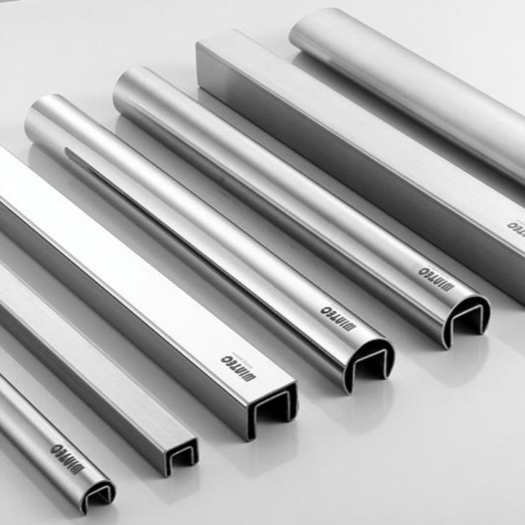 six stainless steel tubes lined up on a table