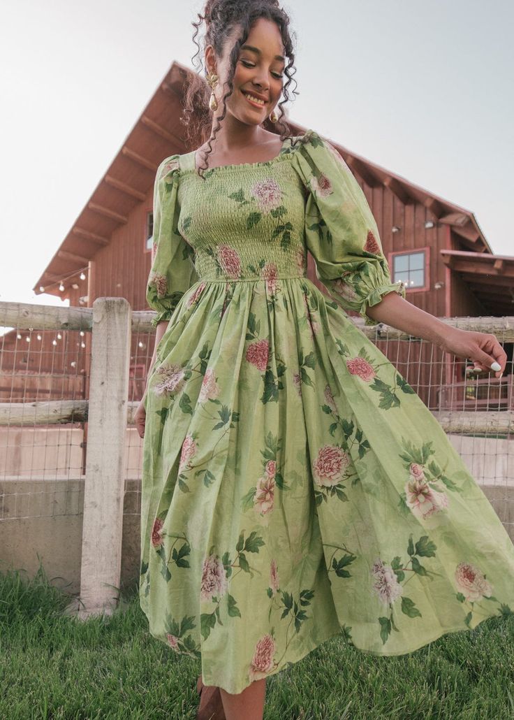 Whispers Of The Woodland This lovely design embodies a dreamy, pastoral charm with its soft green hue and delicate floral pattern. The dress features a smocked bodice that offers a flattering, comfortable fit, while the voluminous, puffed sleeves and square neckline add a touch of vintage elegance. Embrace a timeless, country chic style with the Wren Dress! Square neckline Smocked bodice Elastic puff half sleeve If between sizes, recommend sizing down Model Details Content + Care 100% Cotton Hand Wash Only Hang Dry Try-On Video Wren Dress Try-On Video XXS & L Spring Floral Dress With Gathered Sleeves For Garden Party, Spring Dresses For Gatherings With Smocked Back, Spring Gatherings Dress With Smocked Back, Flowy Smocked Dress With Smocked Back For Garden Party, Spring Garden Party Smocked Dress With Gathered Sleeves, Spring Square Neck Smocked Dress For Garden Party, Spring Smocked Square Neck Dress For Garden Party, Green Dresses With Gathered Sleeves For Brunch, Green Dress With Gathered Sleeves For Brunch