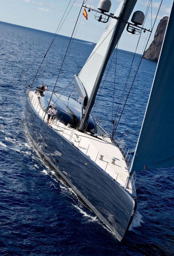 a sailboat sailing in the ocean with people on it's front end and side