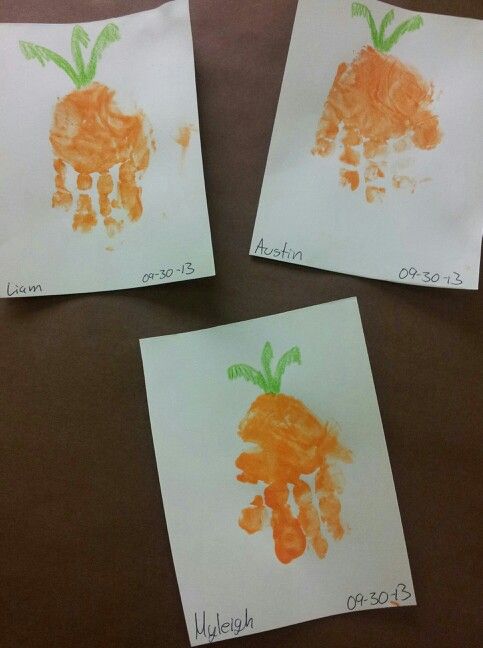 three children's handprints made to look like carrots